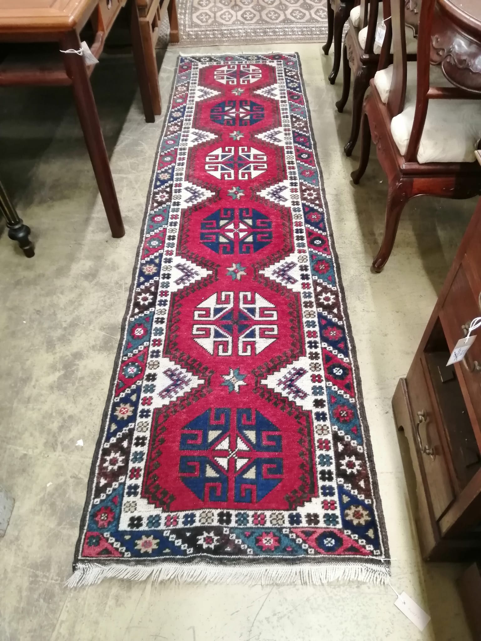 A Caucasian style red ground runner, 274 x 72cm